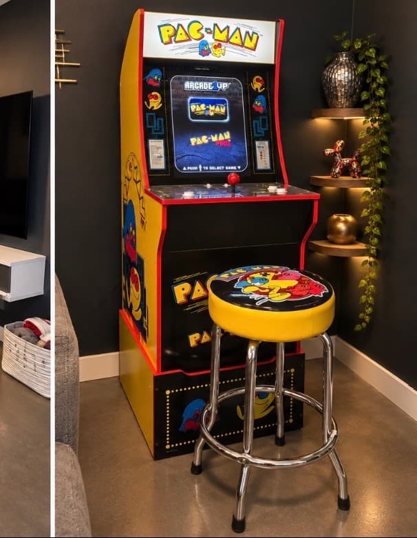 Pac-Man Arcade1Up machine with matching stool and backlit shelving