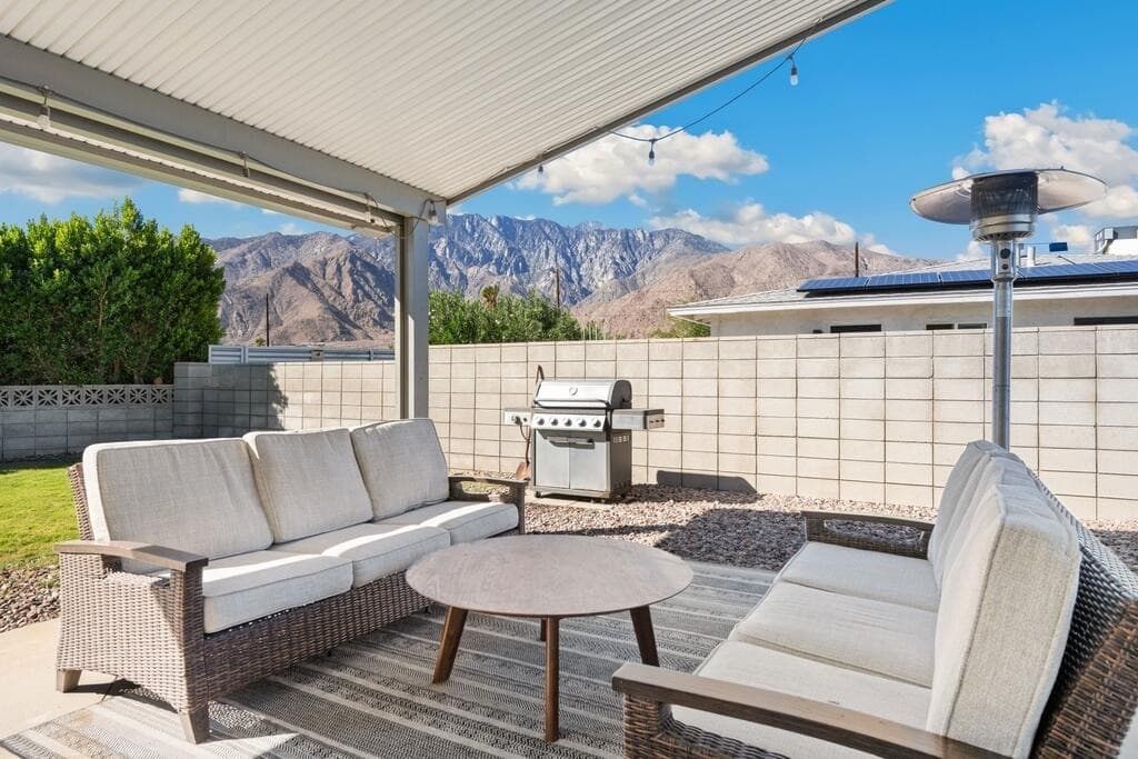 Covered patio with mountain views, BBQ grill and lounge seating
