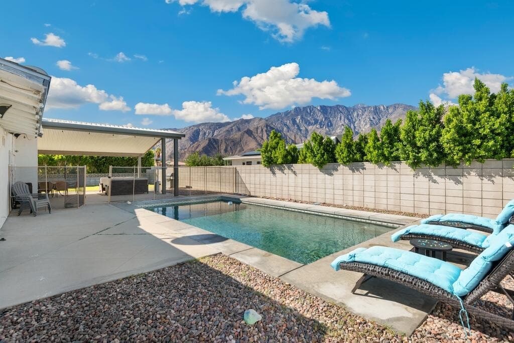 Sun drenched pool and patio with mountain views in Palm Springs