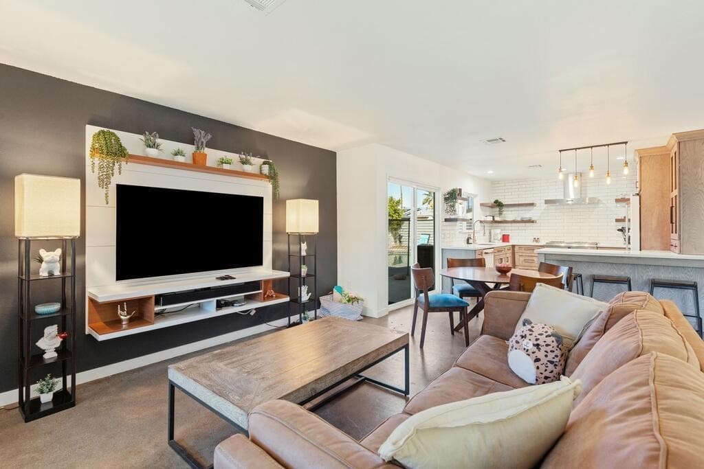 Modern living room with accent wall and open kitchen