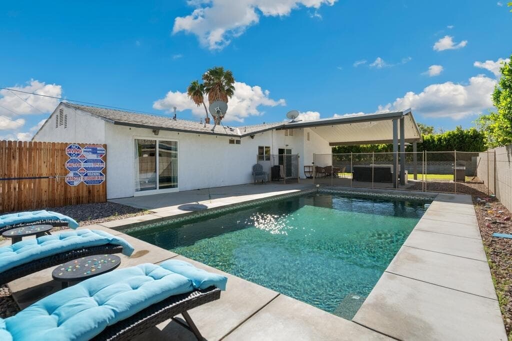 Private pool and patio with blue lounge chairs