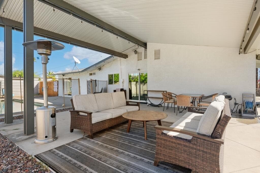 Covered patio with wicker seating and mid-century desert style